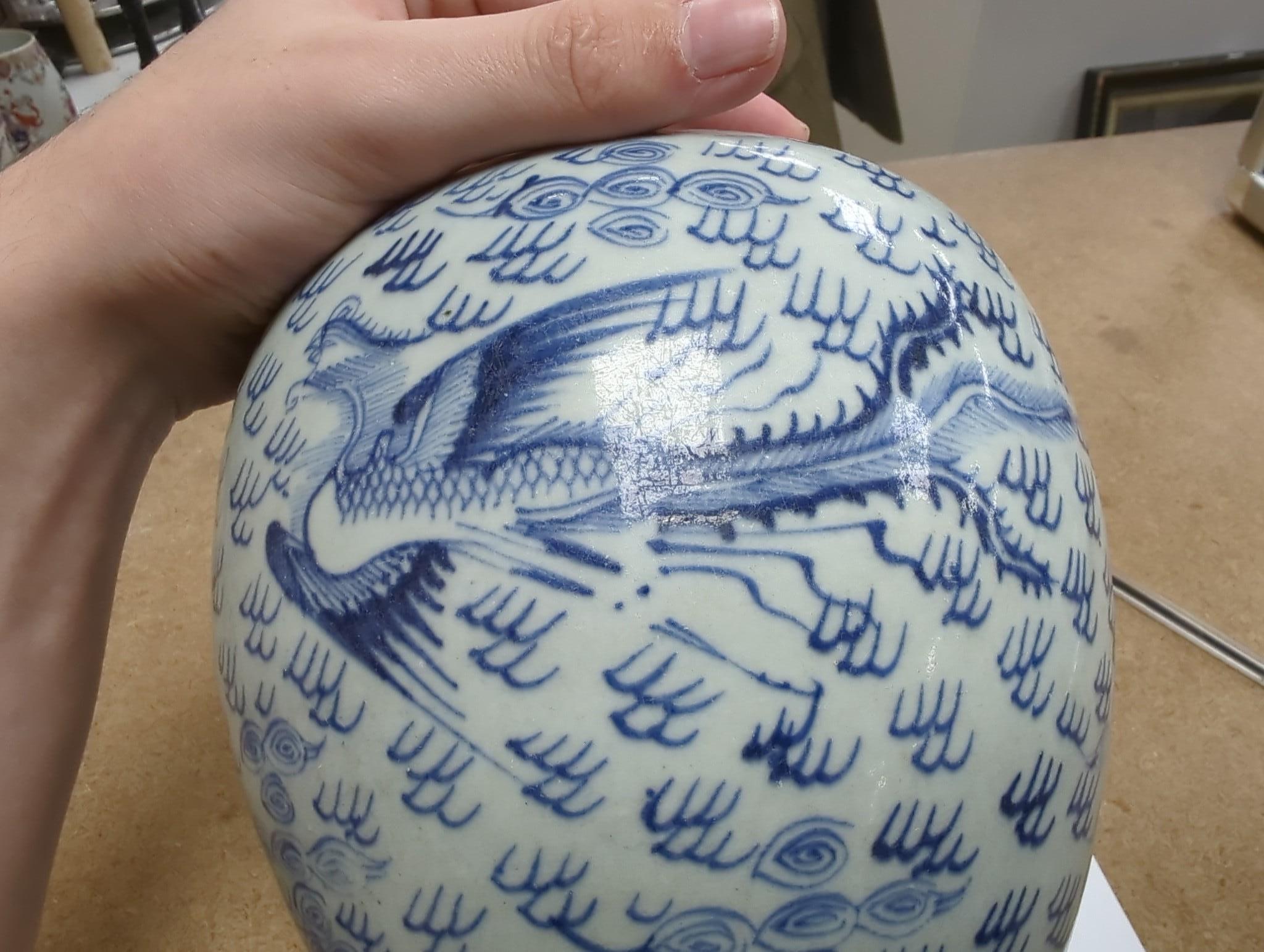 An 18th century Chinese provincial blue and white ‘dragon and phoenix’ jar, 19cm